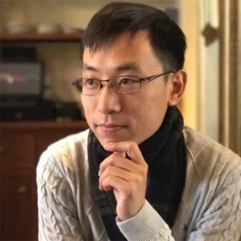 Hongbo Yu wears a sweater indoors